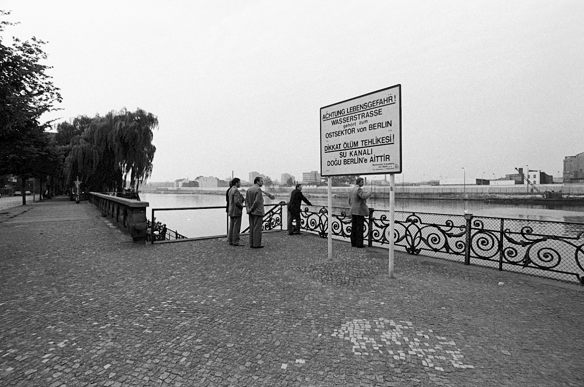 Berlin, ca. 1978 – Personen und Warnschild am Gröbenufer (Fotograf: Heinz Jura)