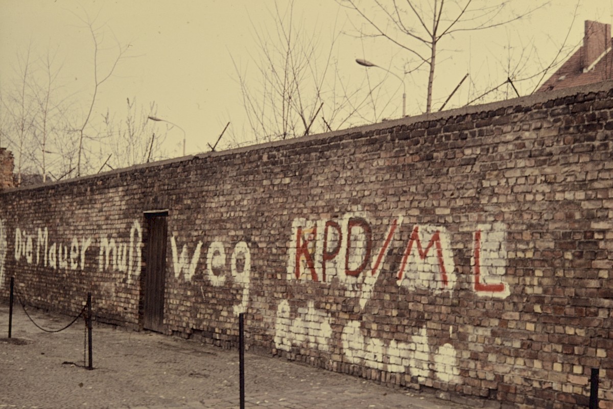 Berlin, März 1977 – Schriftzug auf der Grenzmauer an der Bernauer Straße (Fotograf: Conrad Bicker)